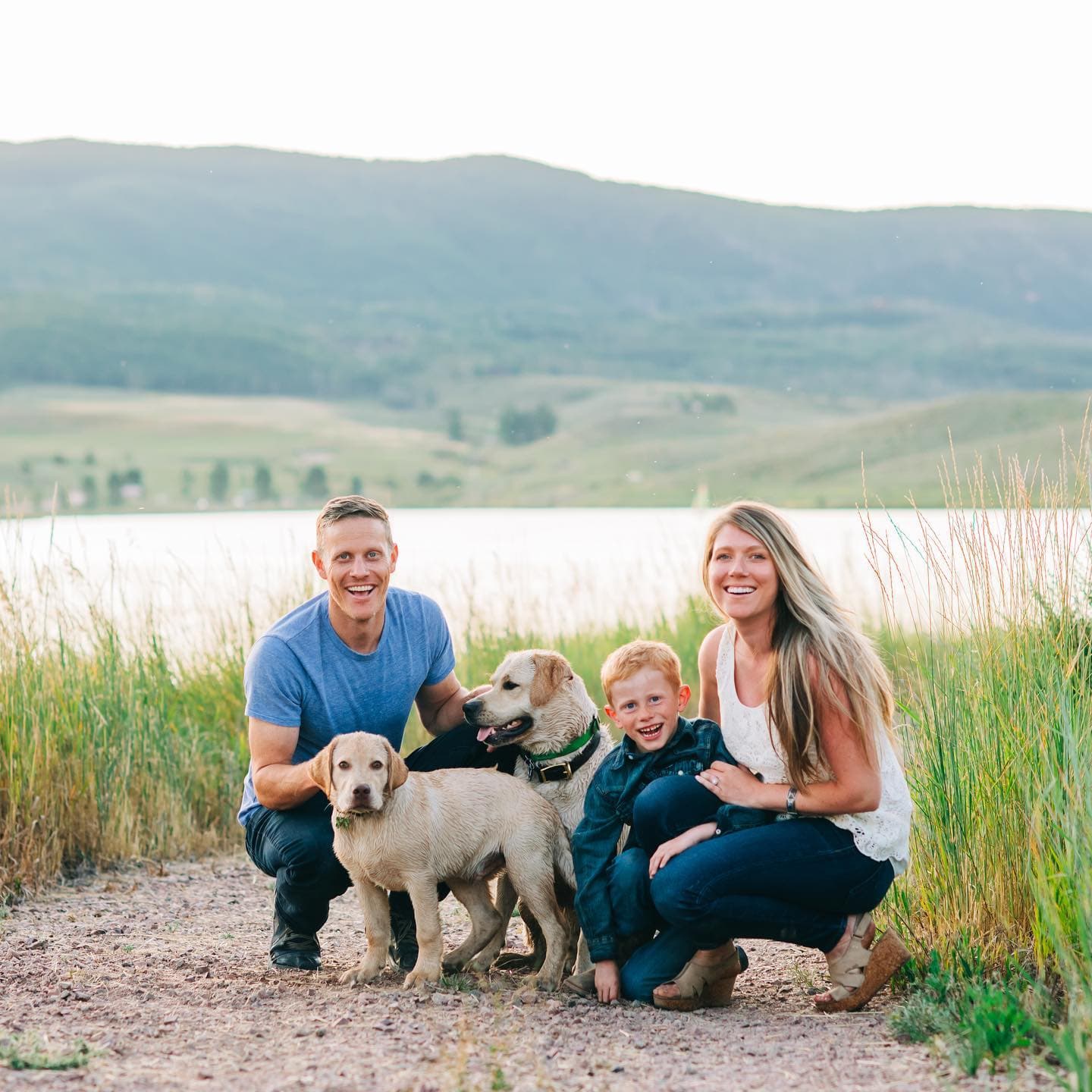 Ryan Shorter with his wife, son, and dogs by a Colorado mountain lake