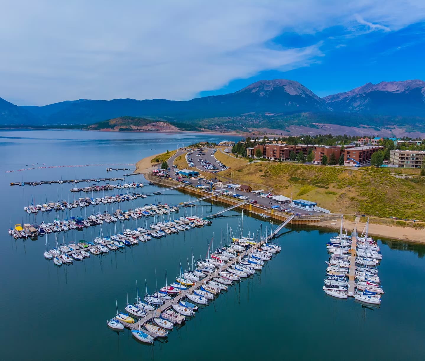 Aerial view of Dillon Marina with sailboats on Dillon Reservoir and mountain peaks in background