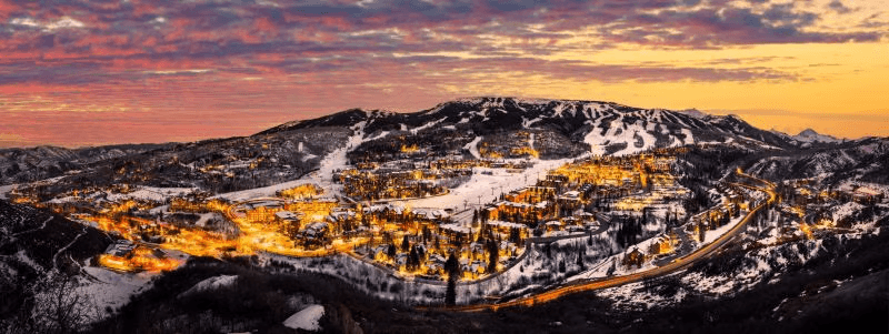 Sunset panorama of Edwards, Colorado with Beaver Creek ski slopes and Vail Valley lights