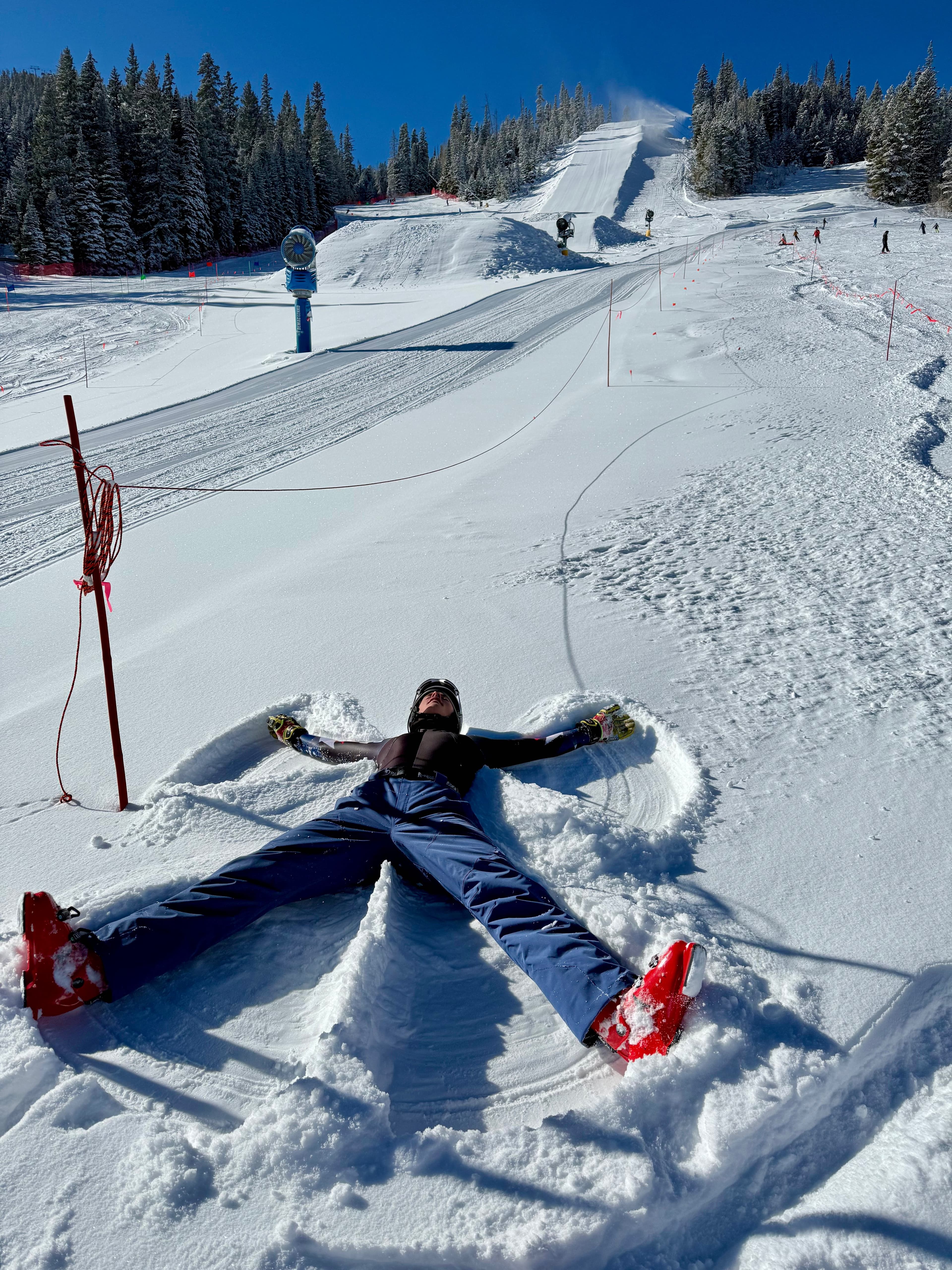 Person making a snow angel on Winter Park ski slopes